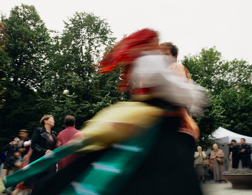 People in motion during a large-scale community arts gathering.